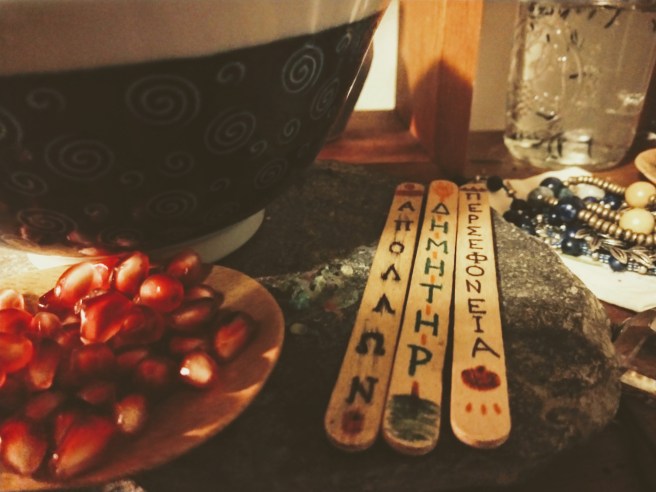 A close-up of the pomegranate seed dish (made of bamboo) and the sticks that have the names of gods on them.